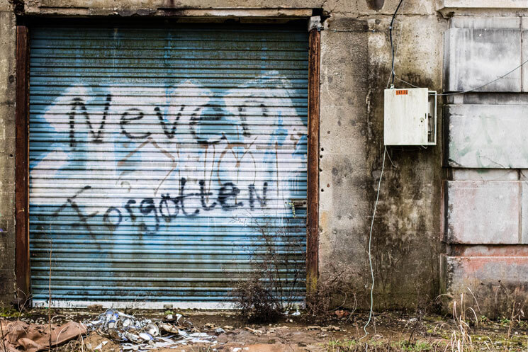 spray painted garage door in abandoned building