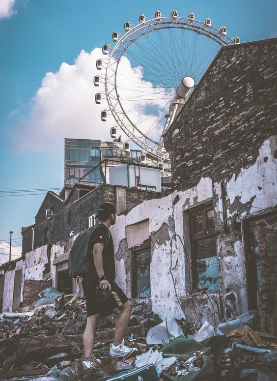 exploring decaying buildings with a ferris wheel in the background