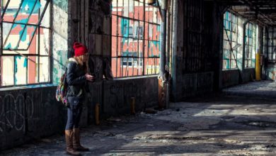 Woman exploring an abandoned building alone