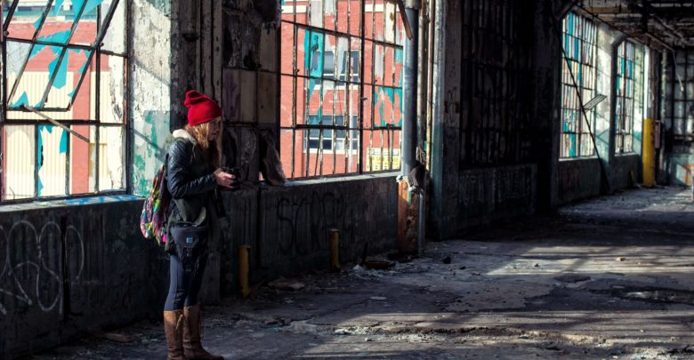 Woman exploring an abandoned building alone