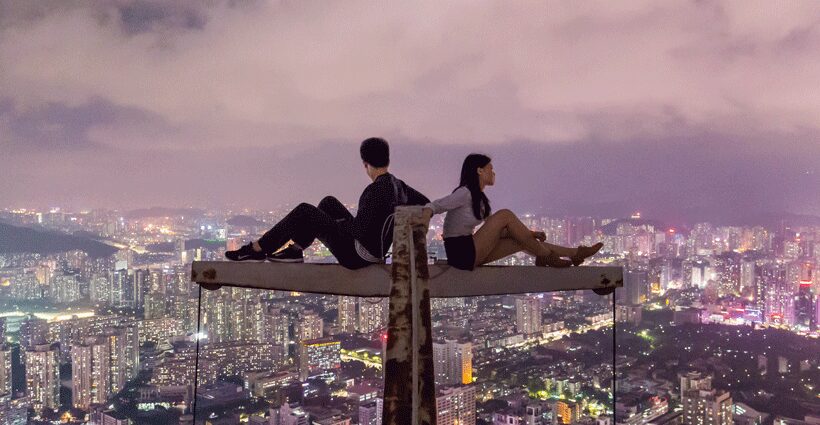 Couple on crane over looking city