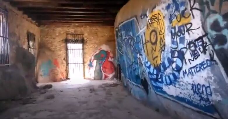 deserted home covered in graffiti