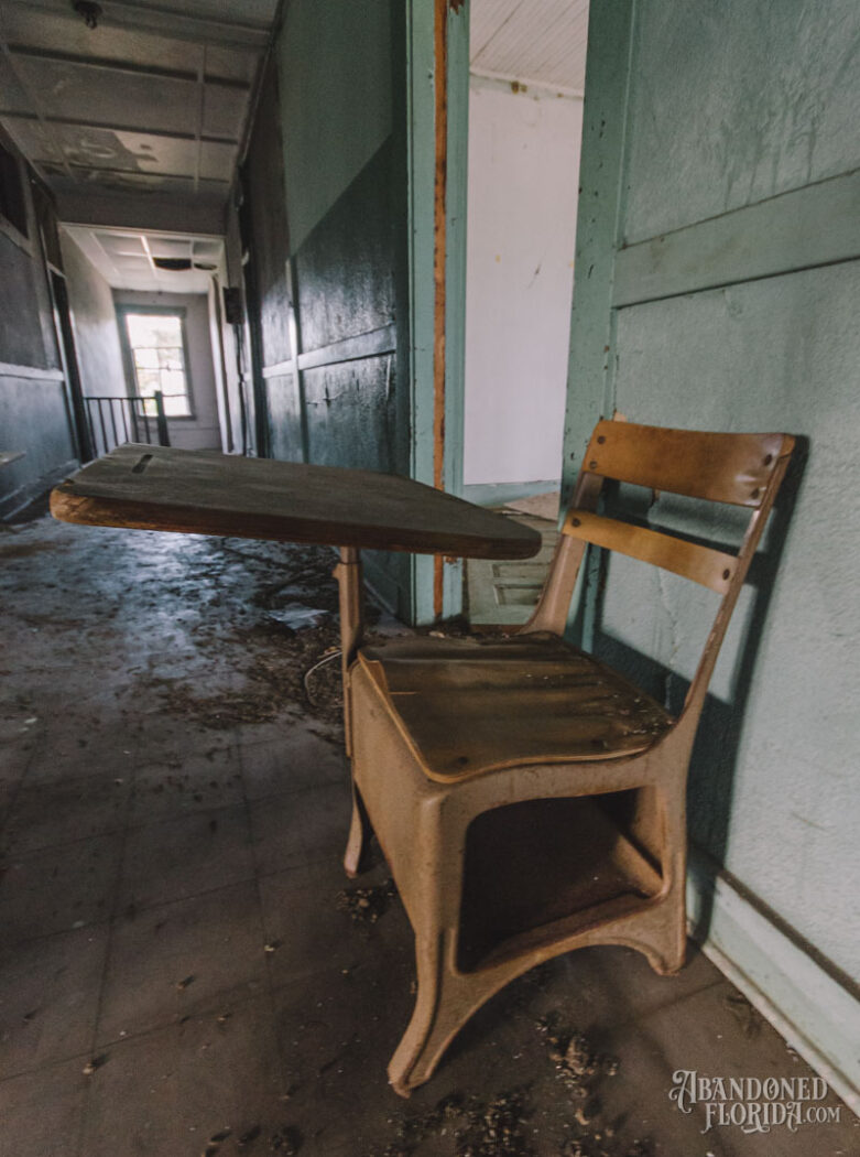 desk in hallway of an empty school